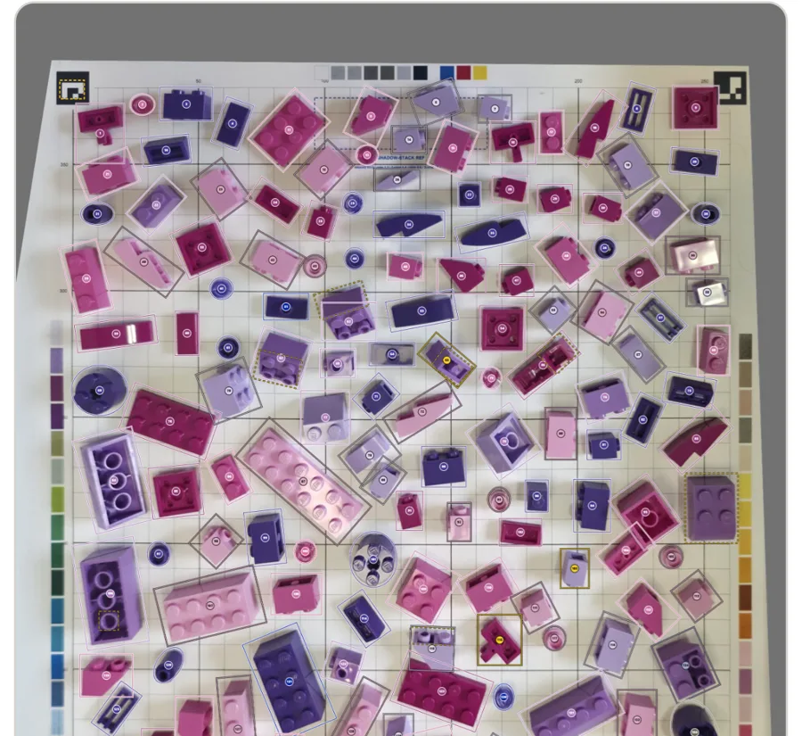 A tray of pink and purple bricks, each one outlined by BrickVision